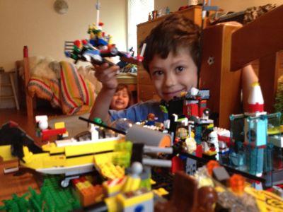Sammy holding up a Lego creation (Sophie in background); Sunnyvale, CA, Tuesday, April 10, 2012