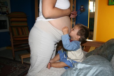 Sammy Mack kisses his mother's pregnant tummy, July 16, 2007, Mountain View, CA
