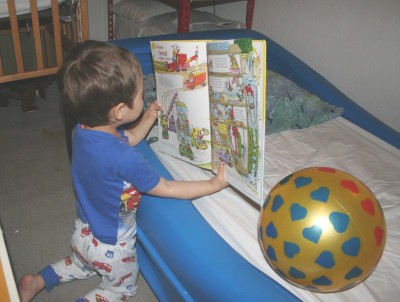 Sammy Mack in his bedroom, reading a Richard Scarry book...to his ball, Mountain View, CA, February 2, 20088