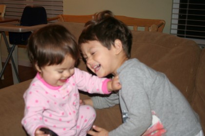 Sammy and Sophie, laughing on the couch, Mountain View, CA, December 12, 2008