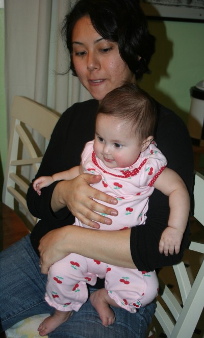 Sophie Mack in a cherry-decorated pink onesie held by Kimi Mack, Mountain View, CA, February 10, 2008