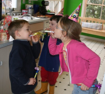 Taylor and Jack exchanging raspberries, with Andy in the background, at the St. Valentine's Day Party, Mountain View, CA, February 2, 2008