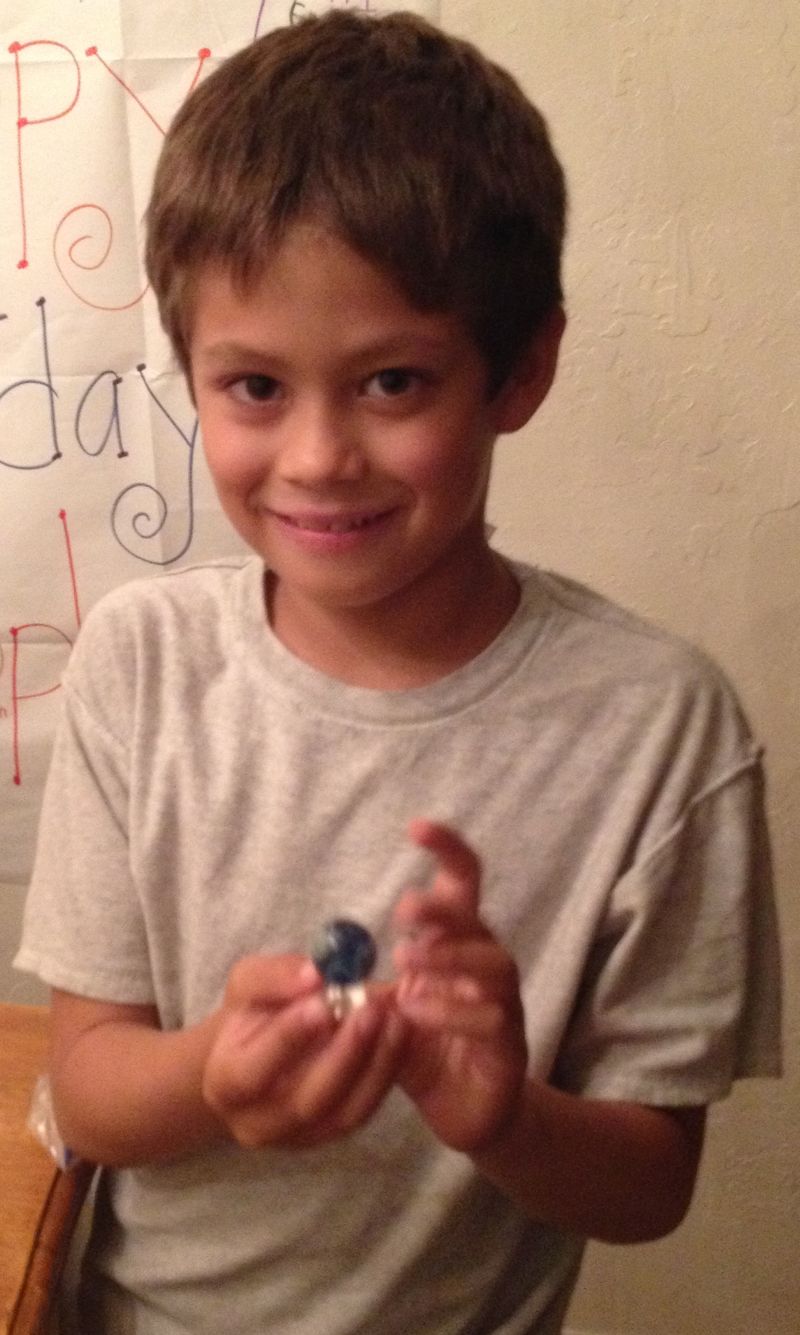 Sammy in 2013, holding a bead Shannon made